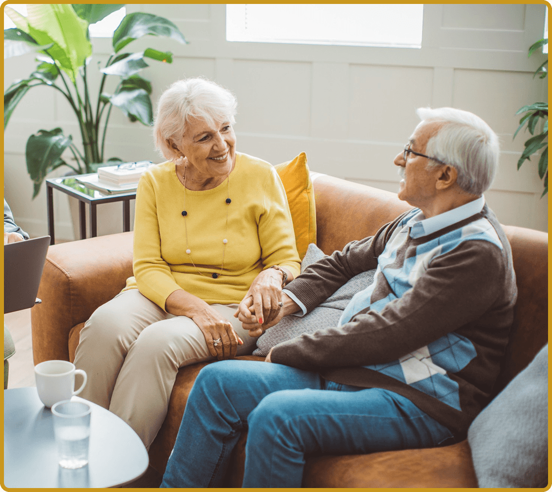 Elderly couple sitting and talking