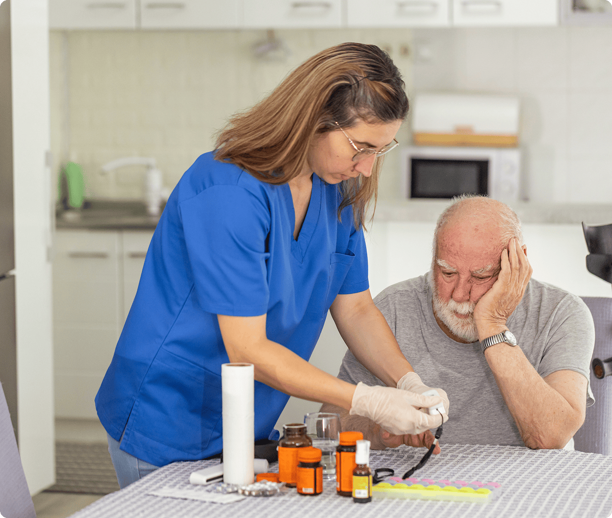 Nurse assisting elderly man with medication management.
