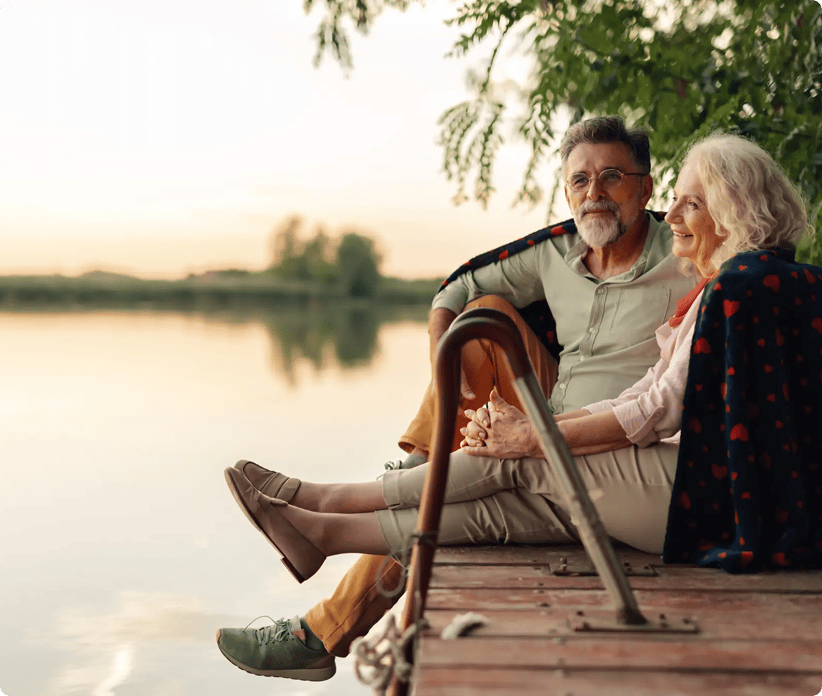 Elderly couple sitting by the lake.